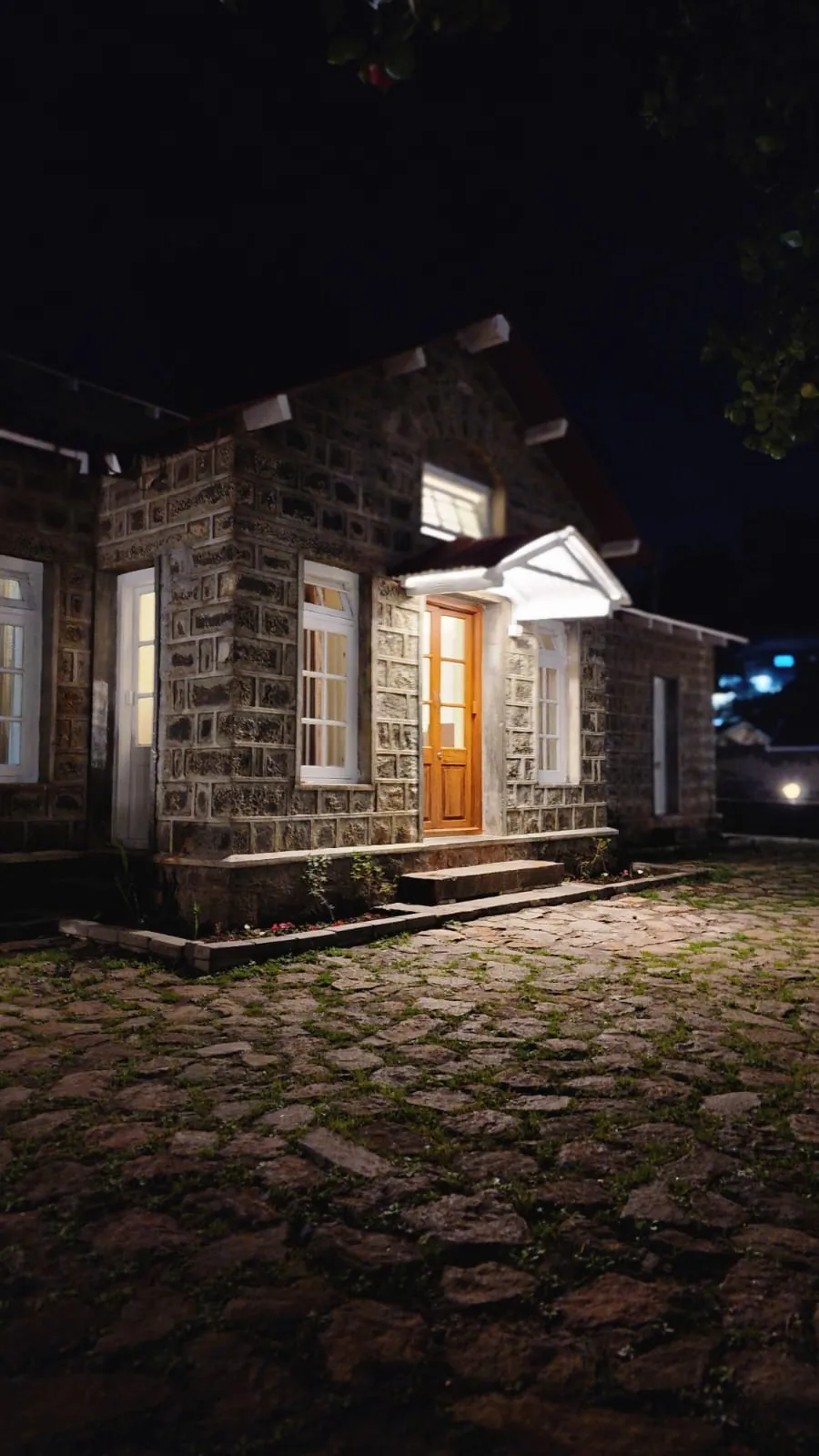 The stone facade lit warmly at night